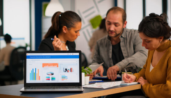 Business woman talking about financial project using laptop